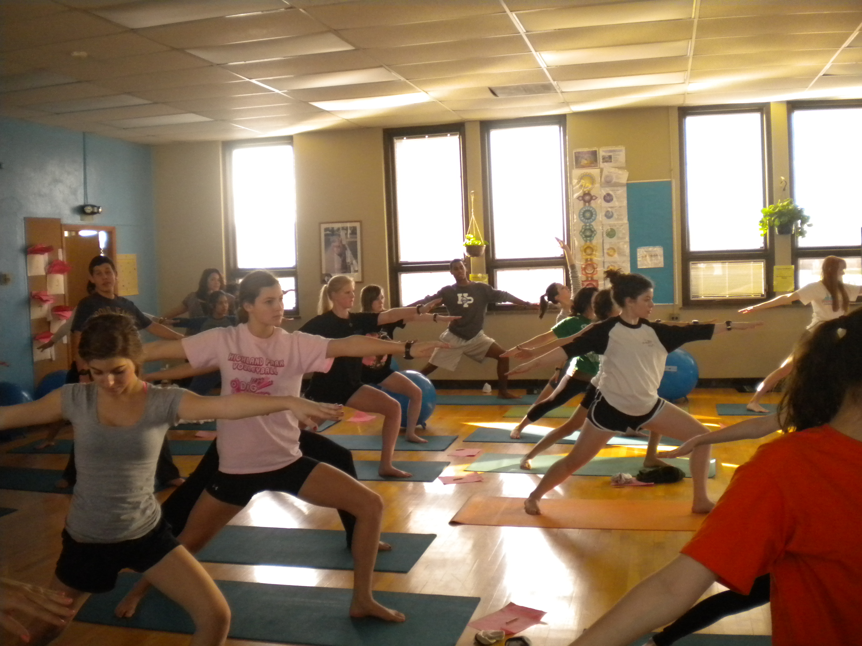 High school students practicing yoga in PE class